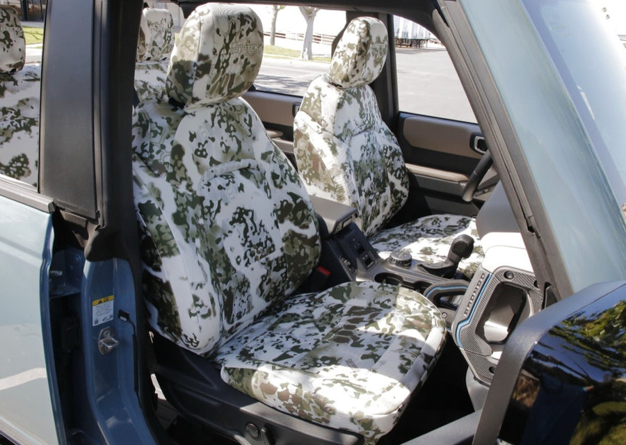 Coverking custom-fit Kryptek seat covers installed in vehicle — precision pattern engineering
