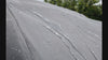 Macro of water sheeting off Coverking Autobody Armor car cover outer layer without soaking through