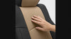 Hand running across Coverking Premium Leatherette custom seat cover surface showing texture and sheen